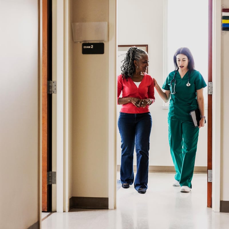 a person walking with a doctor in her hand