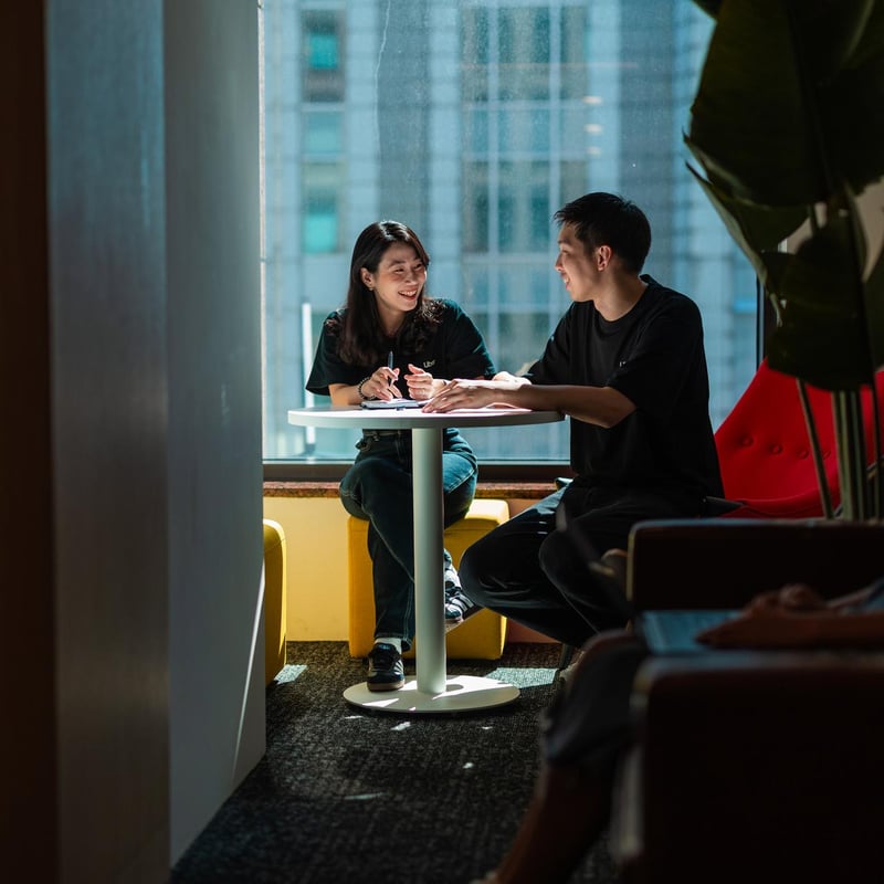 a person and person sitting at a table