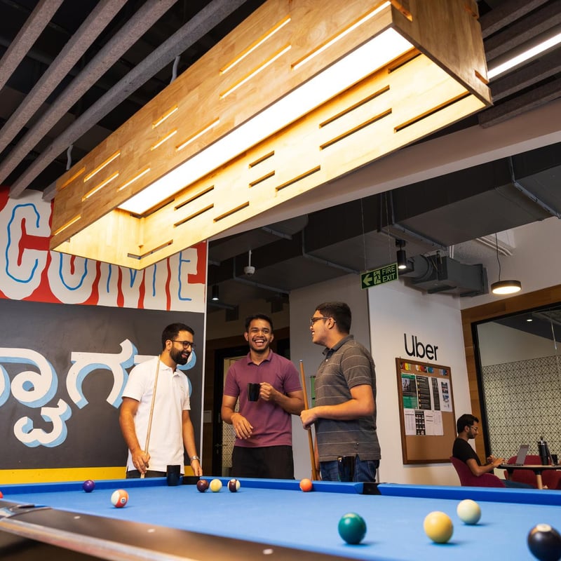 a group of men standing around a pool table
