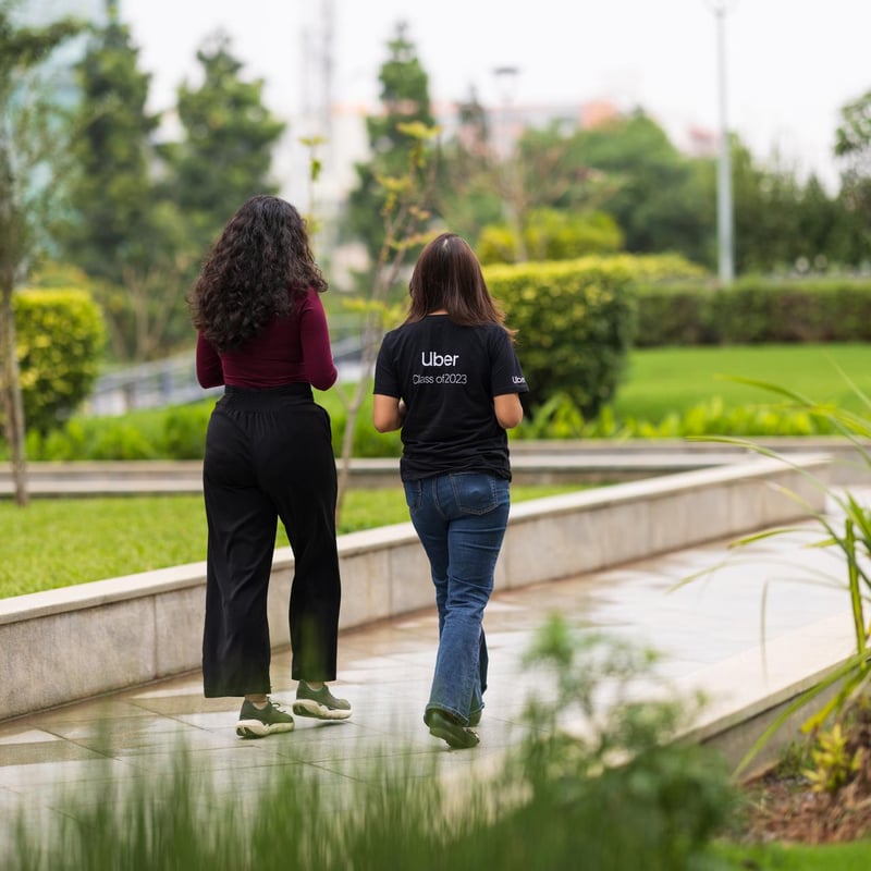 two women walking on a sidewalk
