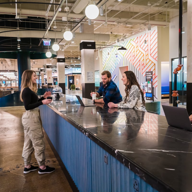 a group of people standing at a counter