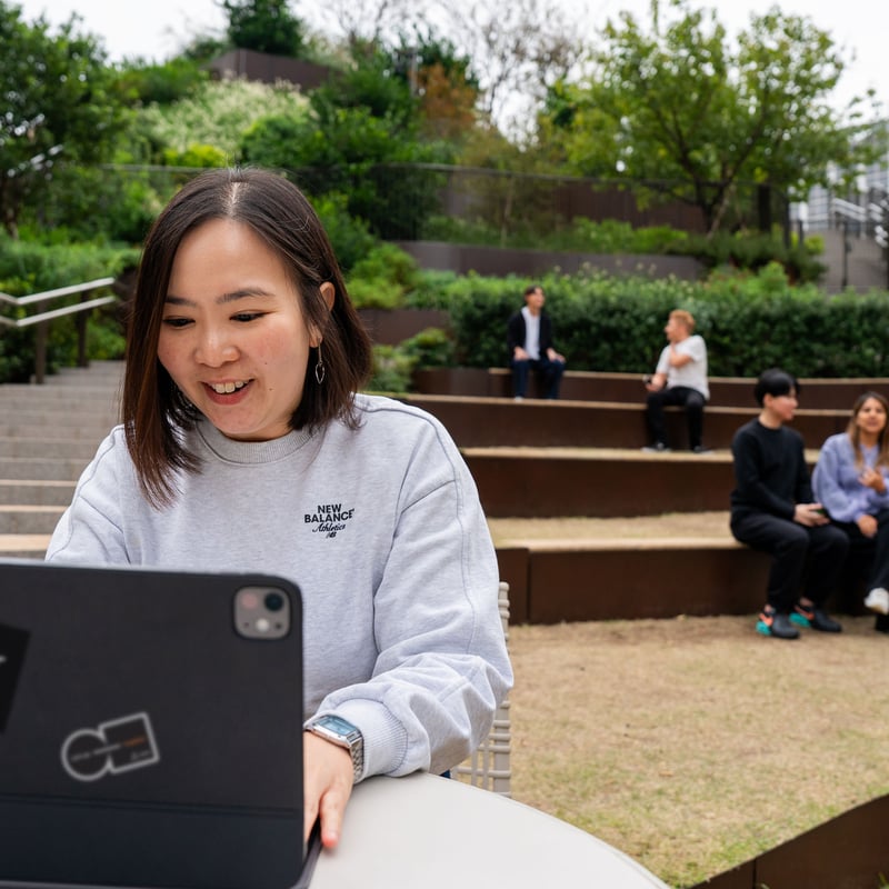 a person sitting at a table with a laptop