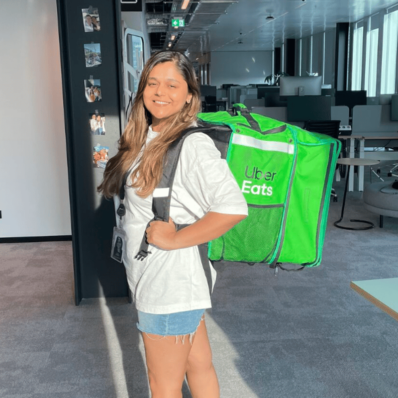 a person carrying a green bag