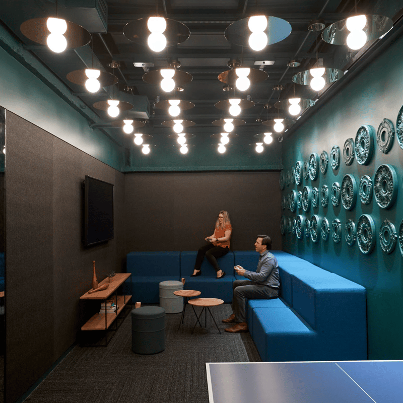 a person and person sitting on a couch in a room with blue walls