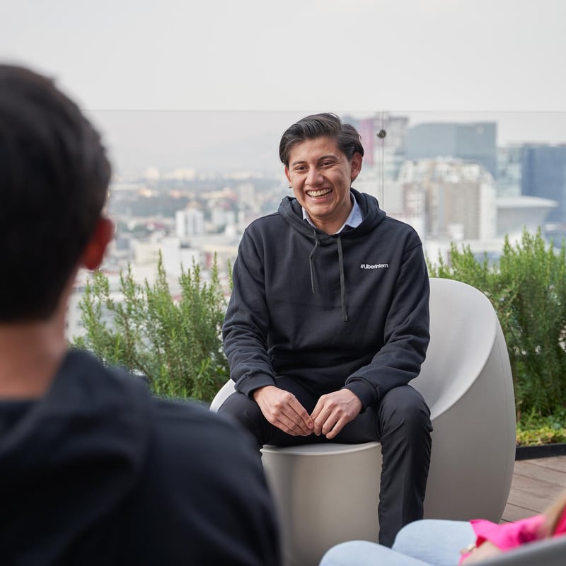 a person sitting in a chair with a city in the background