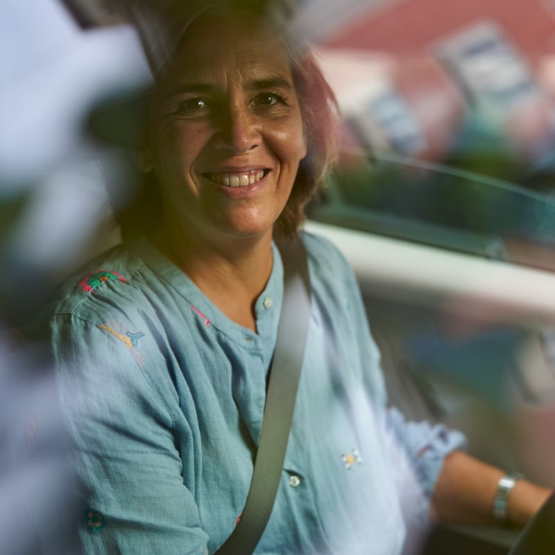 a person smiling in a car