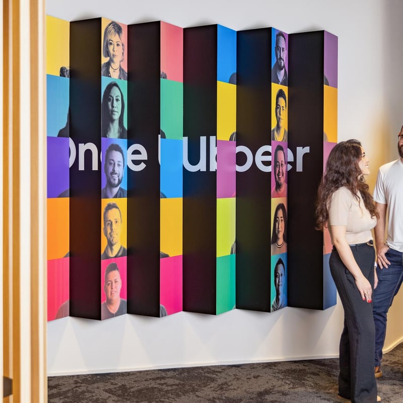 a person and person standing in front of a wall with colorful squares
