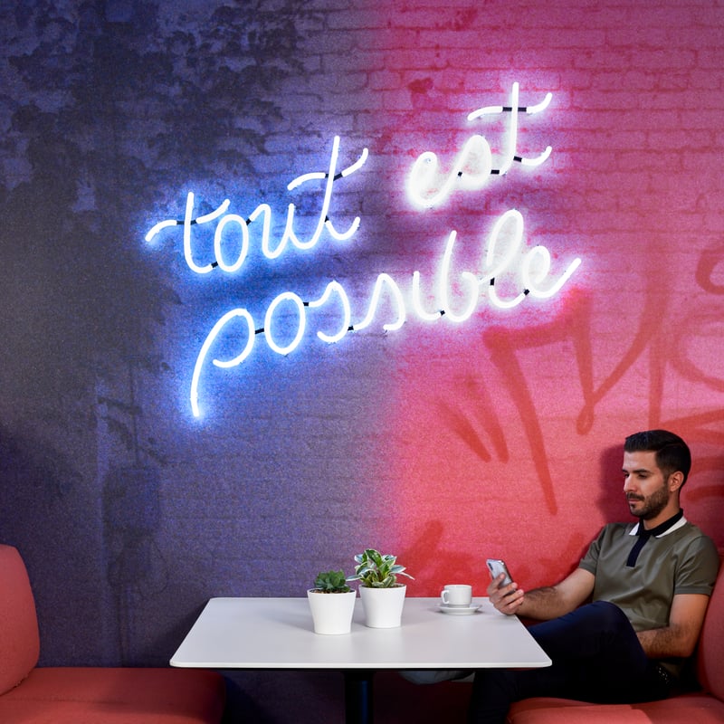 a person sitting at a table with a phone
