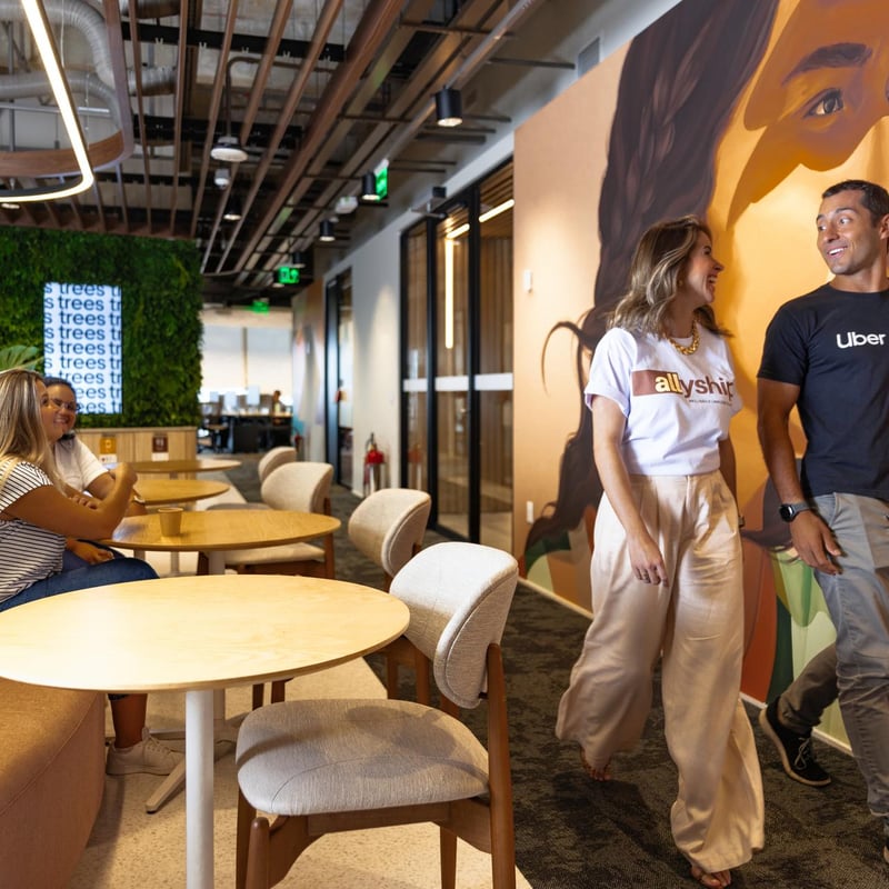 a group of people in a room with tables and chairs