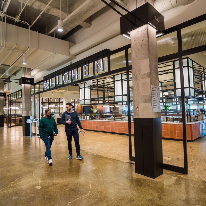 two men walking in a large building