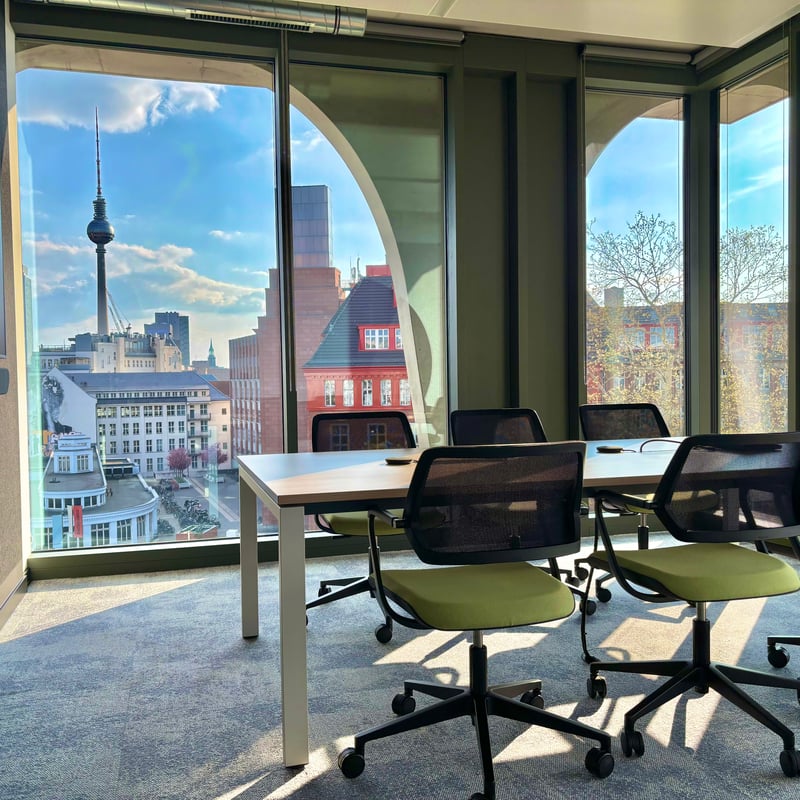a room with a table and chairs and a view of a city