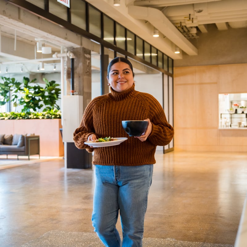 a person holding a plate of food