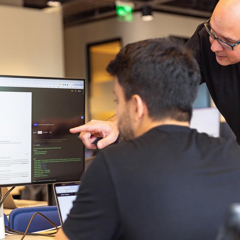 a person pointing at a computer screen