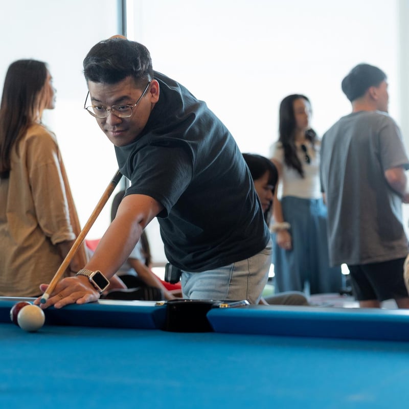 a person playing pool with a stick