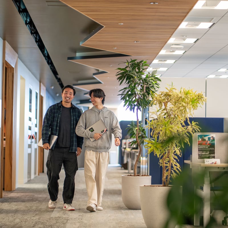 two men walking in a hallway