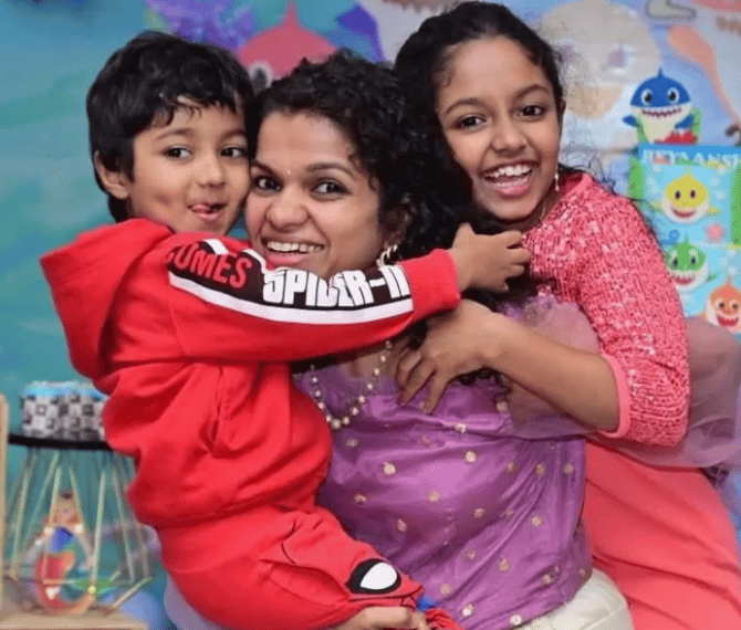 a person holding two children