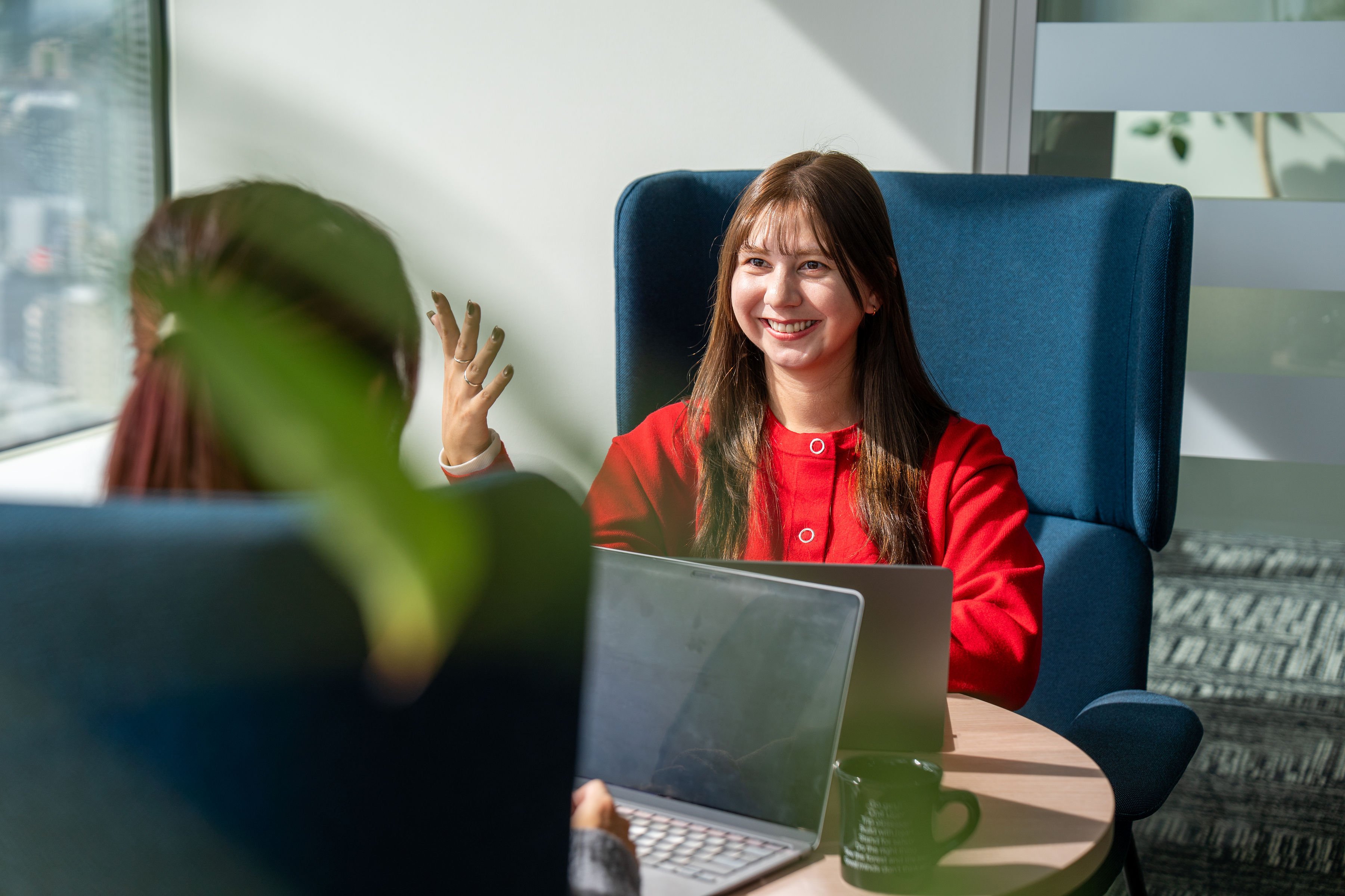 a person sitting at a table with a laptop