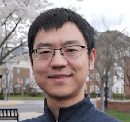 a person wearing glasses and smiling