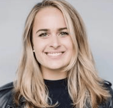 a person with blonde hair smiling