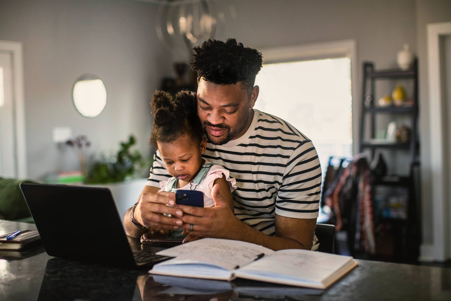 a person and a child looking at a phone